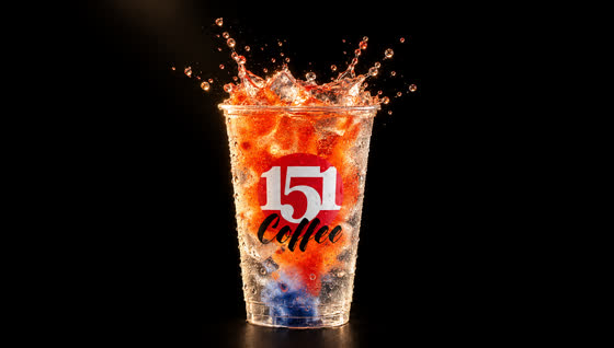Red-orange color detonating through the iced cup